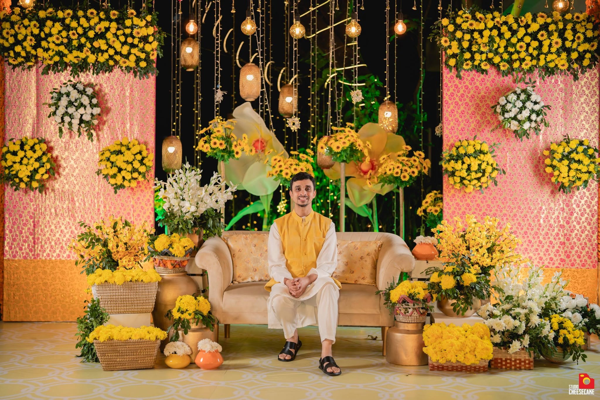 Yellow flowers, woven lanterns and a floral celebration backdrop shared by Silk Route Events